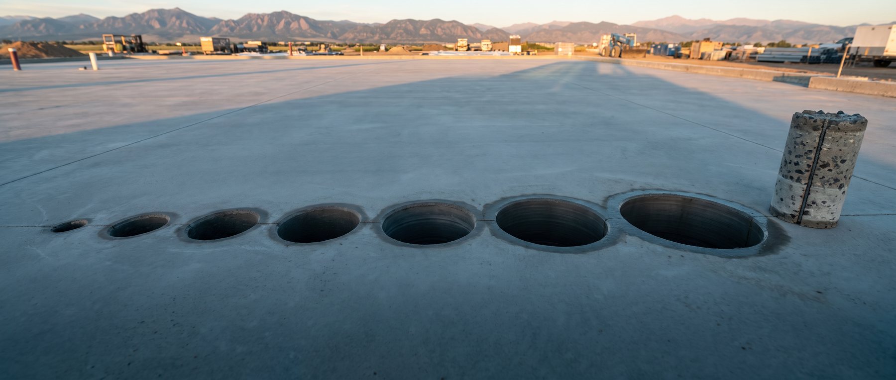 Illustration: a row of core-drilled holes of increasing size in a slab, the pulled core beside the largest