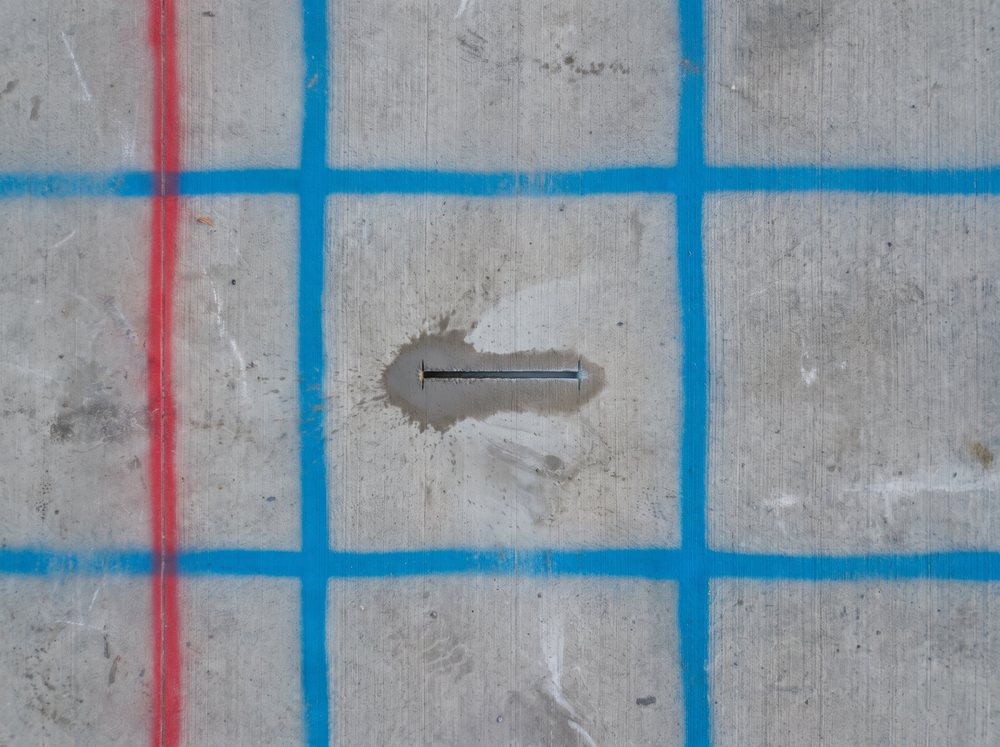 Illustration: a clean saw cut inside a clear square of a slab marked with rebar and conduit lines