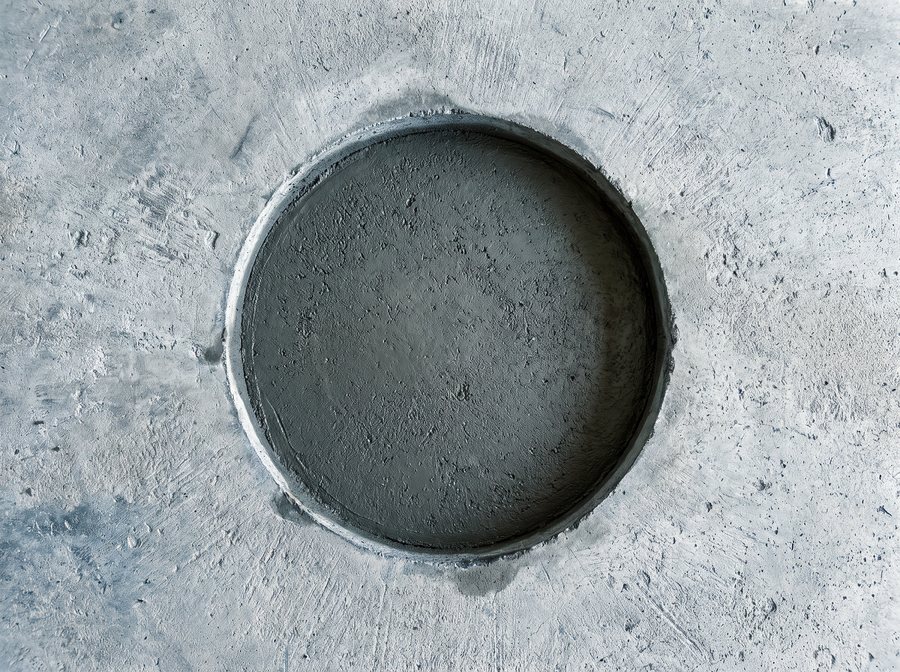Illustration: a core-drilled hole patched flush with the floor