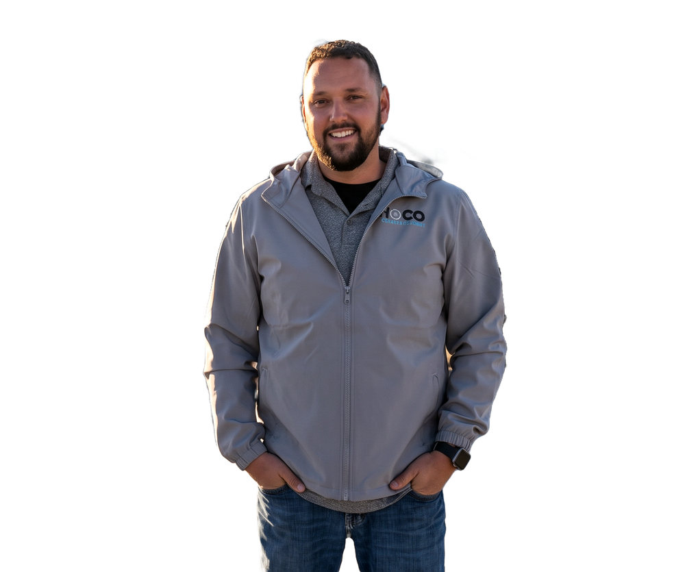 James Heiden, owner of NoCo Concrete Cutting, standing on a concrete slab beside the company truck